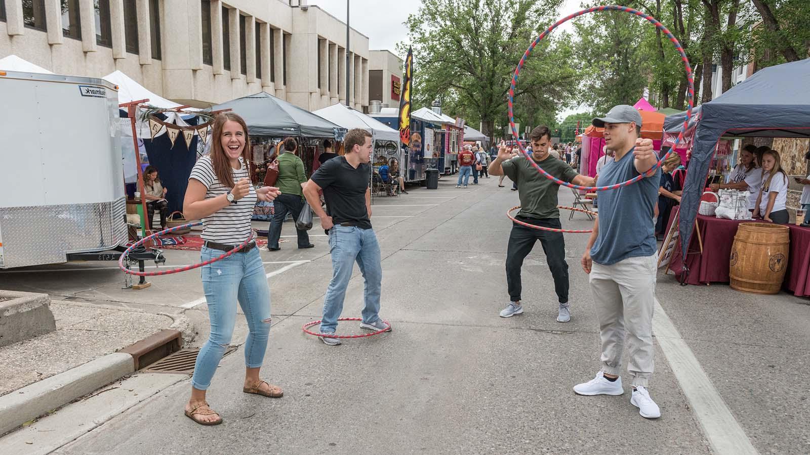 Group of University of Mary students hula hooping at downtown Bismarck street fair
